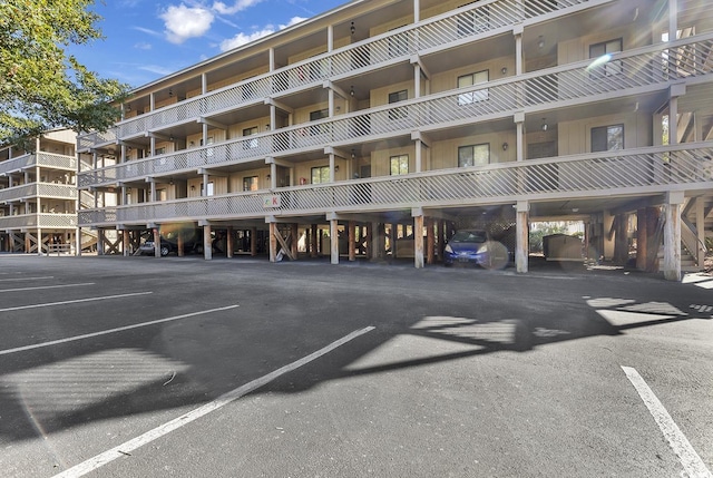 view of building exterior with covered parking