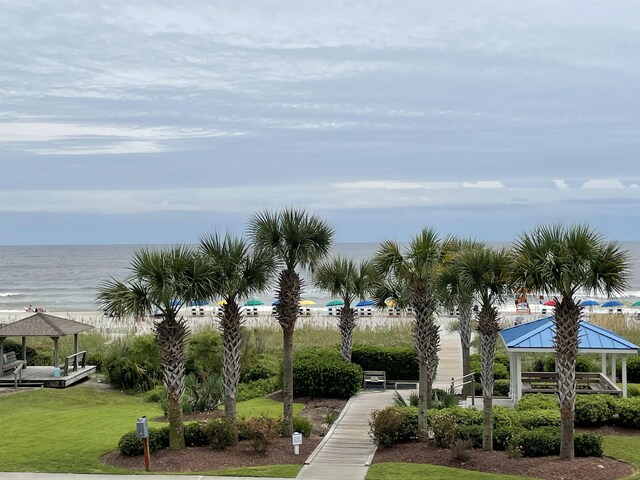 view of home's community with a gazebo, a yard, and a water view