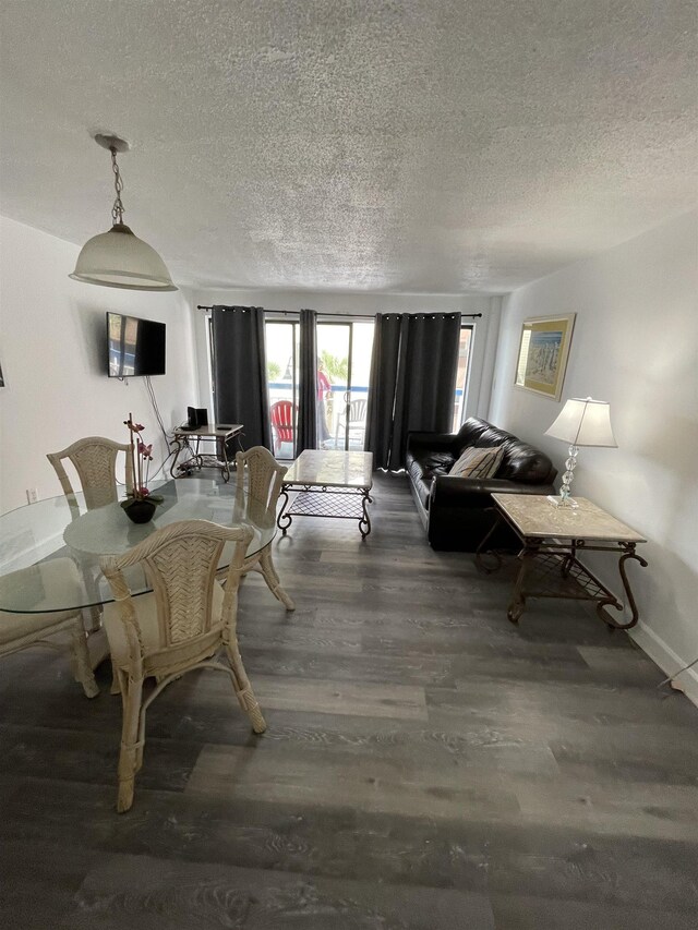 dining space with a textured ceiling and wood-type flooring