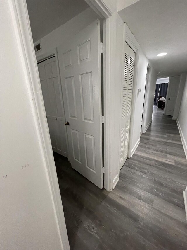 corridor with hardwood / wood-style floors