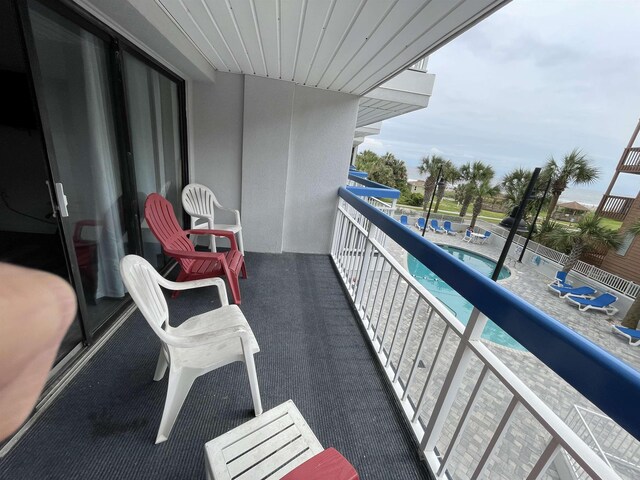 balcony featuring a fenced in pool