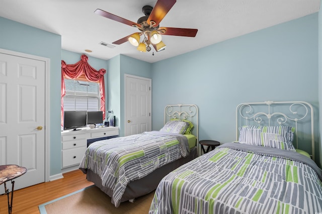 bedroom with ceiling fan and light hardwood / wood-style flooring