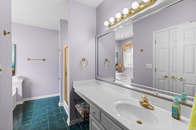 bathroom with tile patterned flooring, a tub to relax in, and vanity