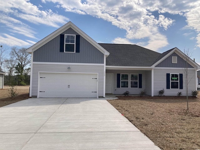 view of front facade with a garage, driveway, and a shingled roof