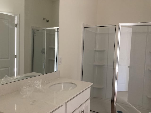 bathroom featuring vanity and a shower with shower door