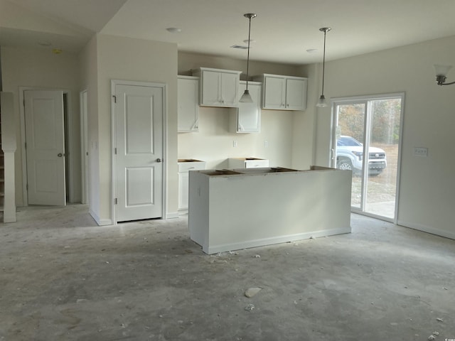 kitchen featuring a center island, hanging light fixtures, and white cabinets