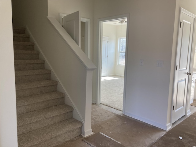 stairway featuring baseboards