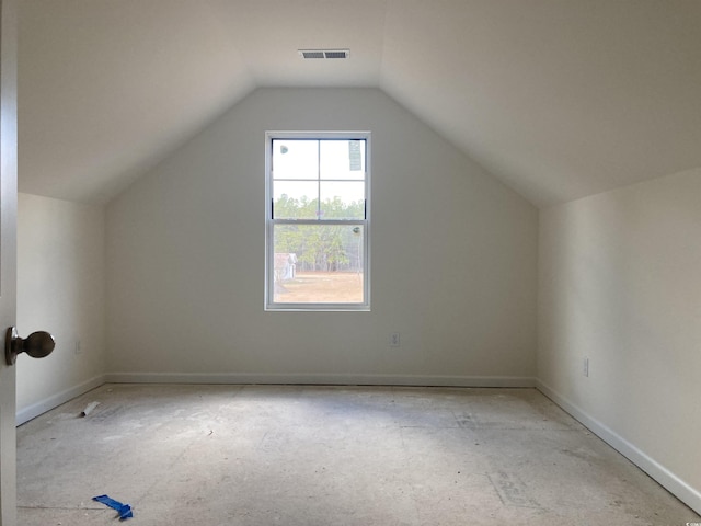 additional living space featuring lofted ceiling and visible vents