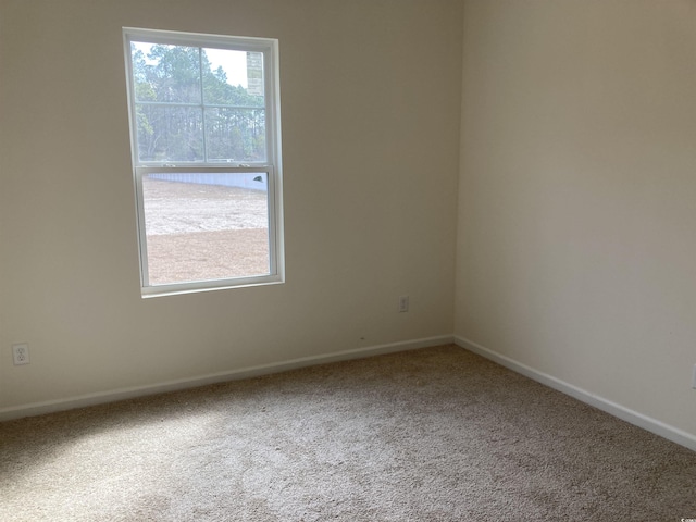 empty room with carpet floors and baseboards