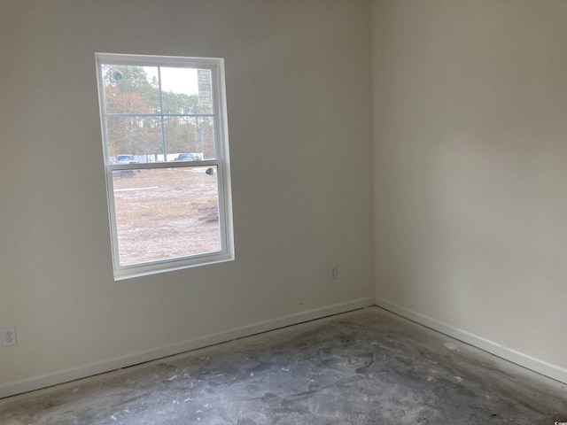 spare room with baseboards