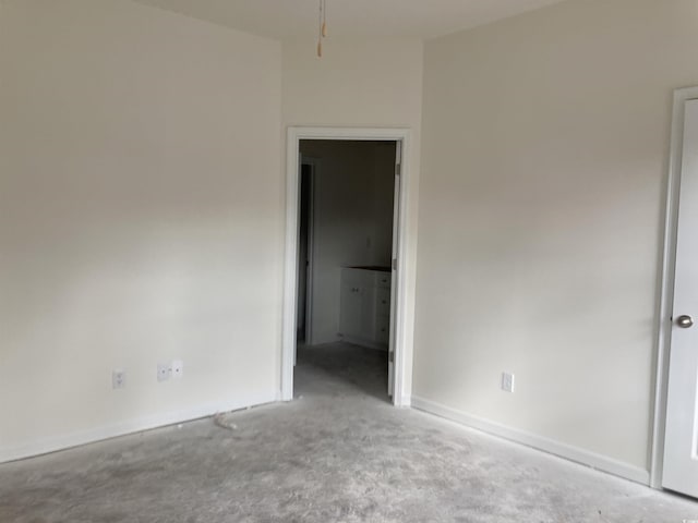 carpeted spare room with baseboards