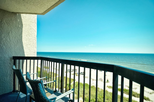 balcony with a view of the beach and a water view