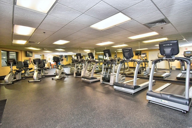 gym with a paneled ceiling