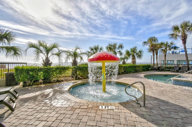 exterior space with pool water feature and a patio area