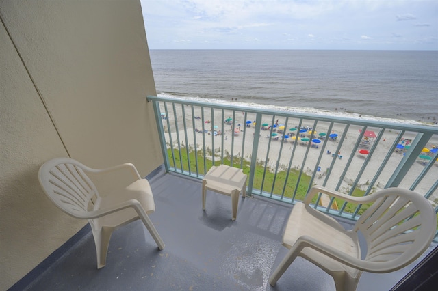 balcony with a water view and a beach view