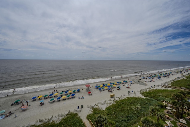 bird's eye view featuring a water view and a beach view