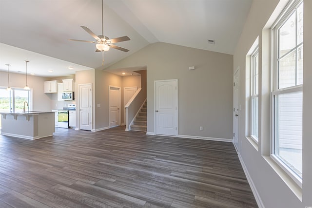 unfurnished living room with vaulted ceiling, ceiling fan, sink, and dark hardwood / wood-style floors