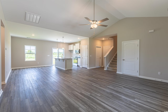 unfurnished living room featuring dark hardwood / wood-style floors, ceiling fan, lofted ceiling, and sink