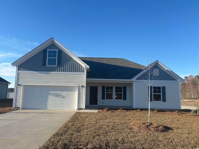 view of front of property featuring a garage and a front lawn