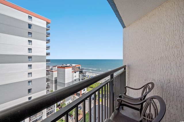 balcony featuring a water view and a view of the beach