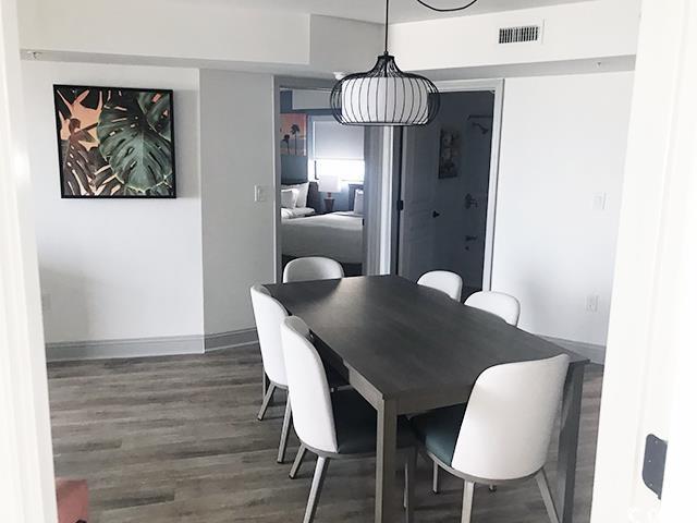 dining space with wood finished floors and baseboards