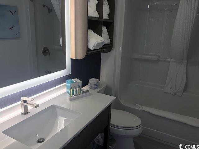 full bathroom featuring vanity, bathing tub / shower combination, and toilet
