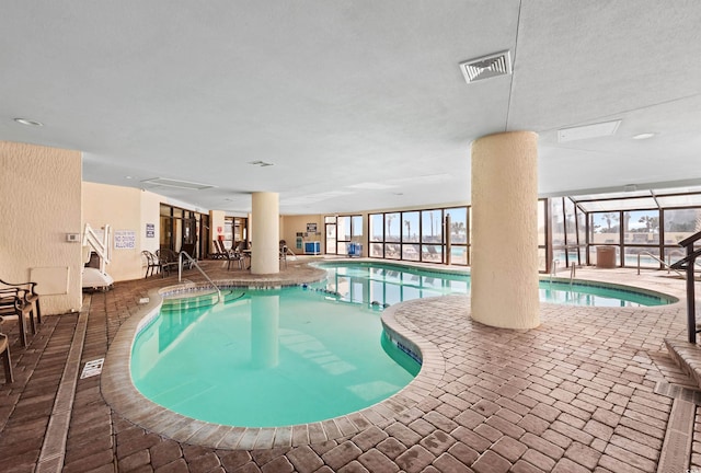 indoor pool with a patio and a lanai
