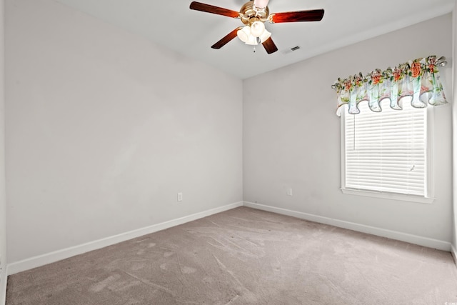 empty room featuring ceiling fan and carpet