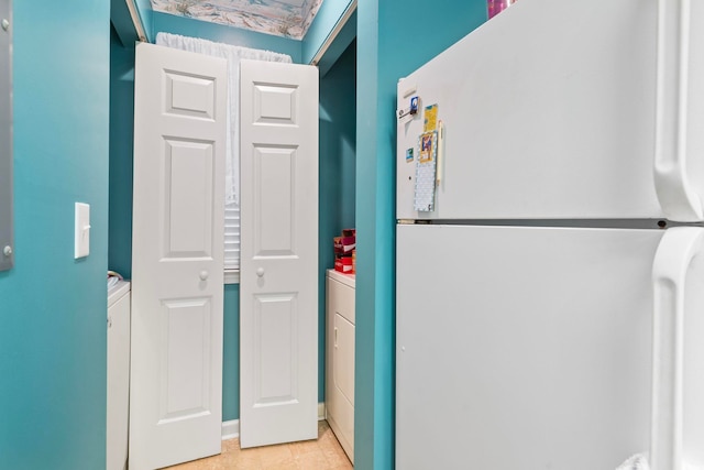 interior space with white fridge and light tile patterned floors