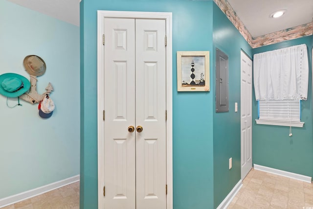 hallway with electric panel and light tile patterned floors