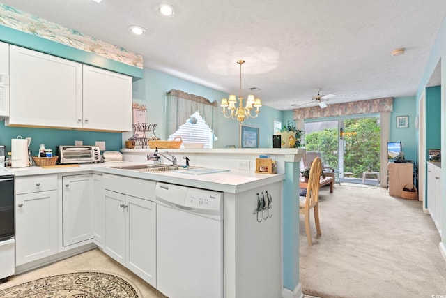 kitchen with sink, white cabinets, kitchen peninsula, and dishwasher