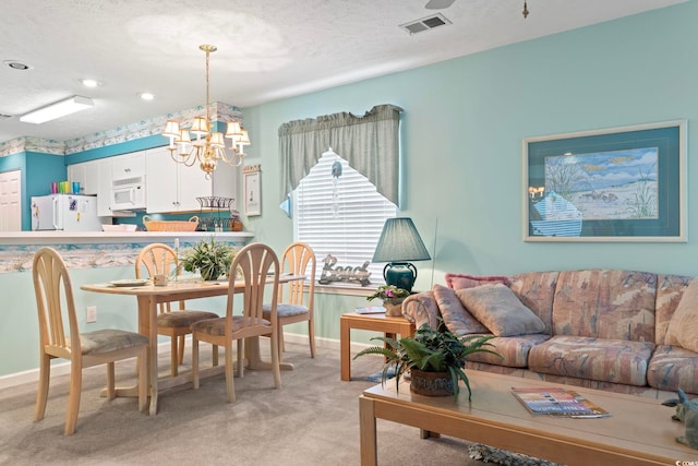 interior space with a notable chandelier, a textured ceiling, and light carpet