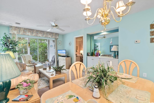 dining room featuring ceiling fan with notable chandelier