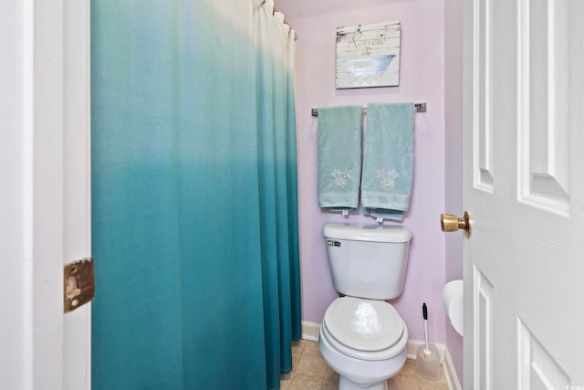 bathroom with tile patterned floors and toilet