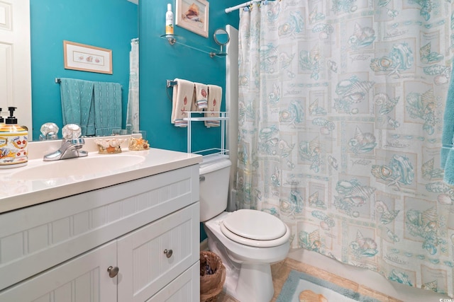 bathroom with tile patterned flooring, vanity, and toilet