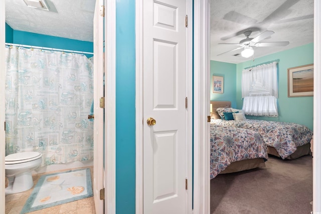 bathroom featuring tile patterned floors, a textured ceiling, ceiling fan, toilet, and a shower with curtain