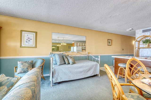 living area with visible vents, carpet floors, and a textured ceiling
