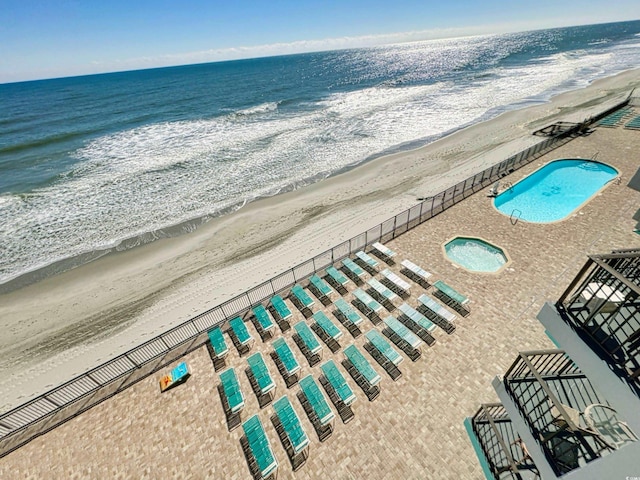 drone / aerial view featuring a beach view and a water view