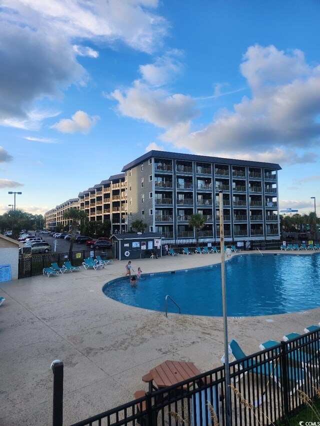 view of swimming pool featuring a patio area