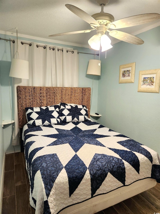 bedroom with ceiling fan, a textured ceiling, and wood finished floors