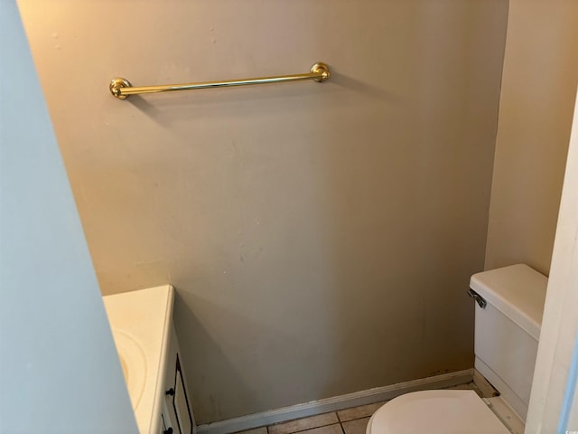 bathroom featuring vanity, tile patterned flooring, and toilet