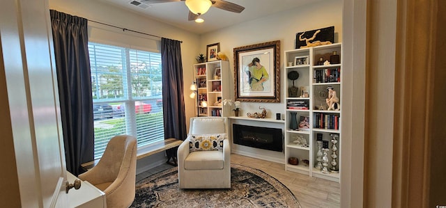 sitting room featuring a wealth of natural light, light hardwood / wood-style floors, and ceiling fan