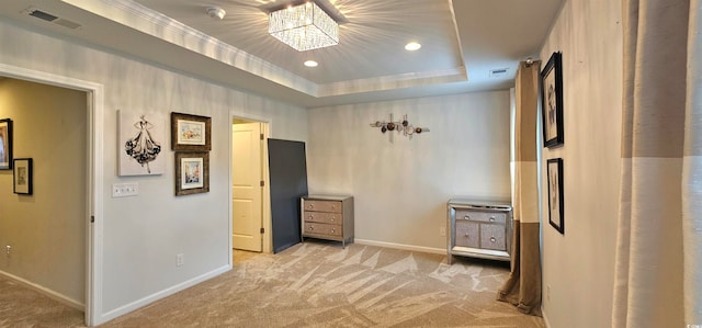 interior space with carpet flooring and a tray ceiling