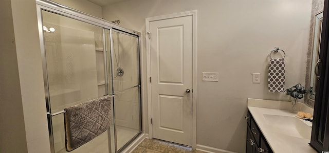 bathroom featuring tile patterned flooring, vanity, and walk in shower