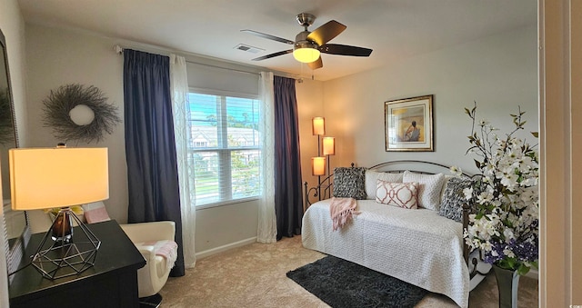 bedroom with ceiling fan and light colored carpet