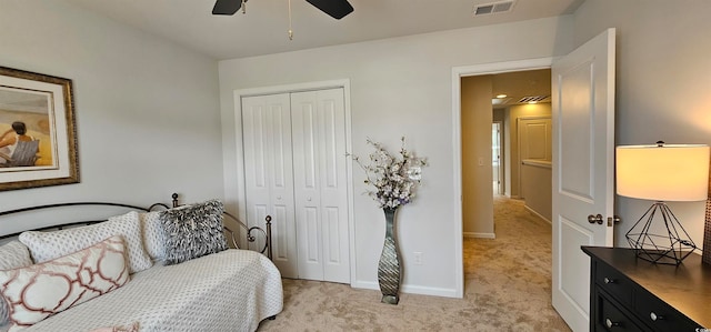 carpeted bedroom with ceiling fan and a closet