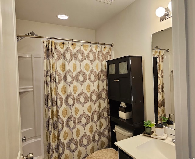 full bathroom featuring vanity, shower / tub combo, and toilet