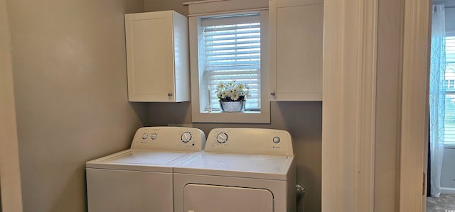 washroom with washing machine and dryer and cabinets