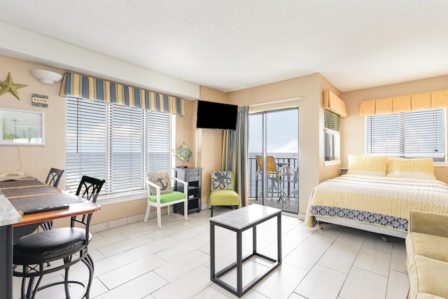 tiled bedroom featuring a textured ceiling