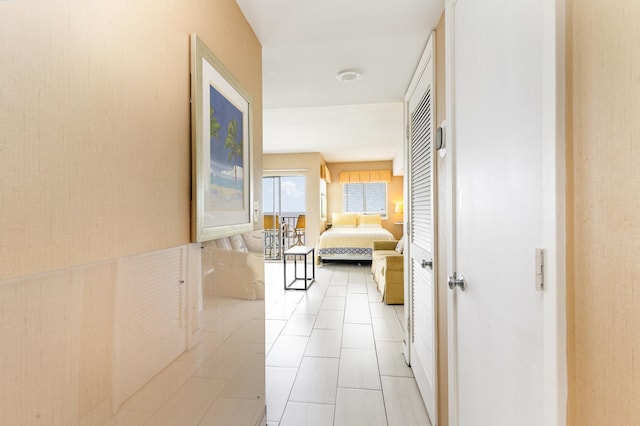 hall featuring light tile patterned floors